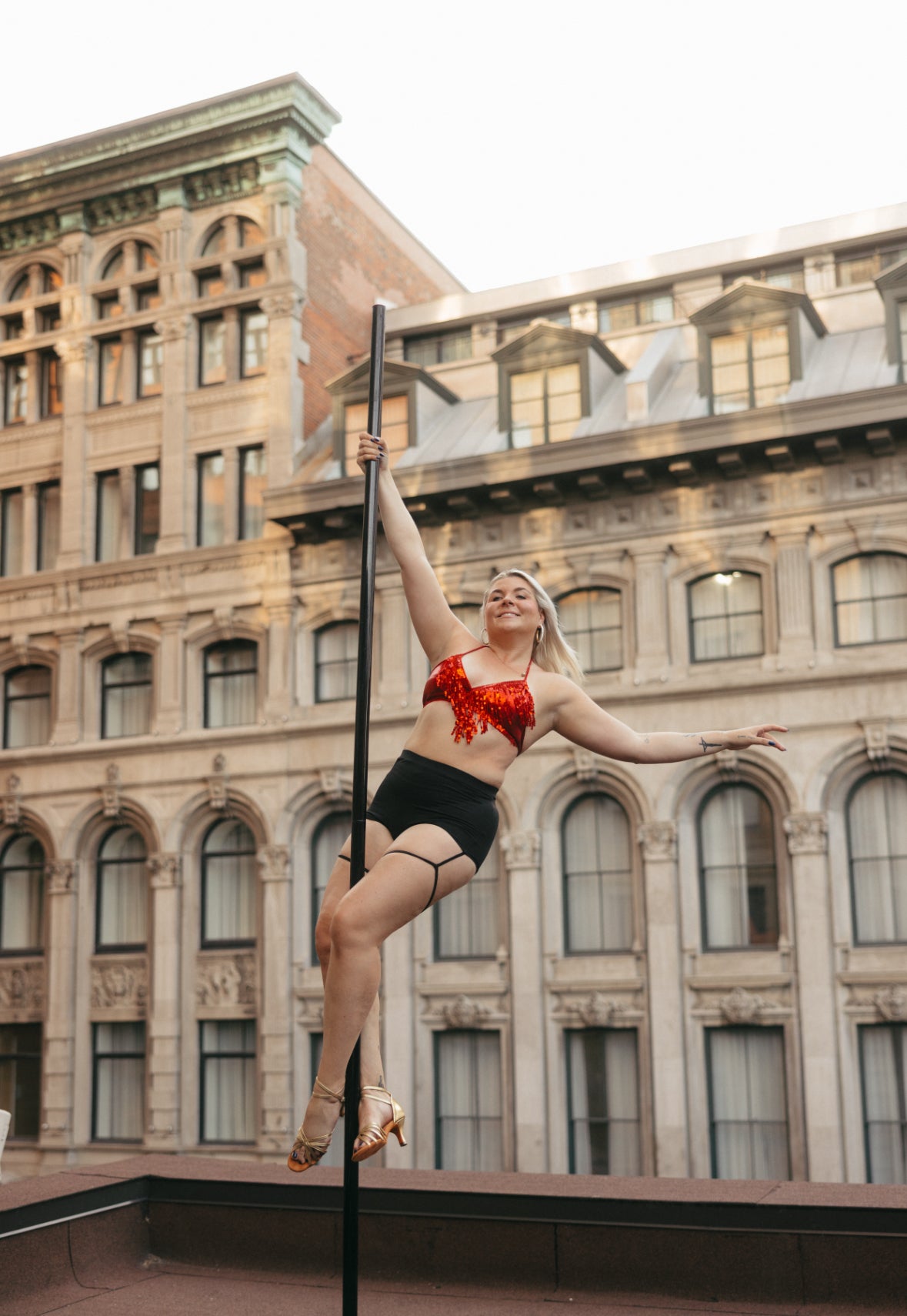 Person practicing pole dancing and latin dance in a dance studio in Brossard.
