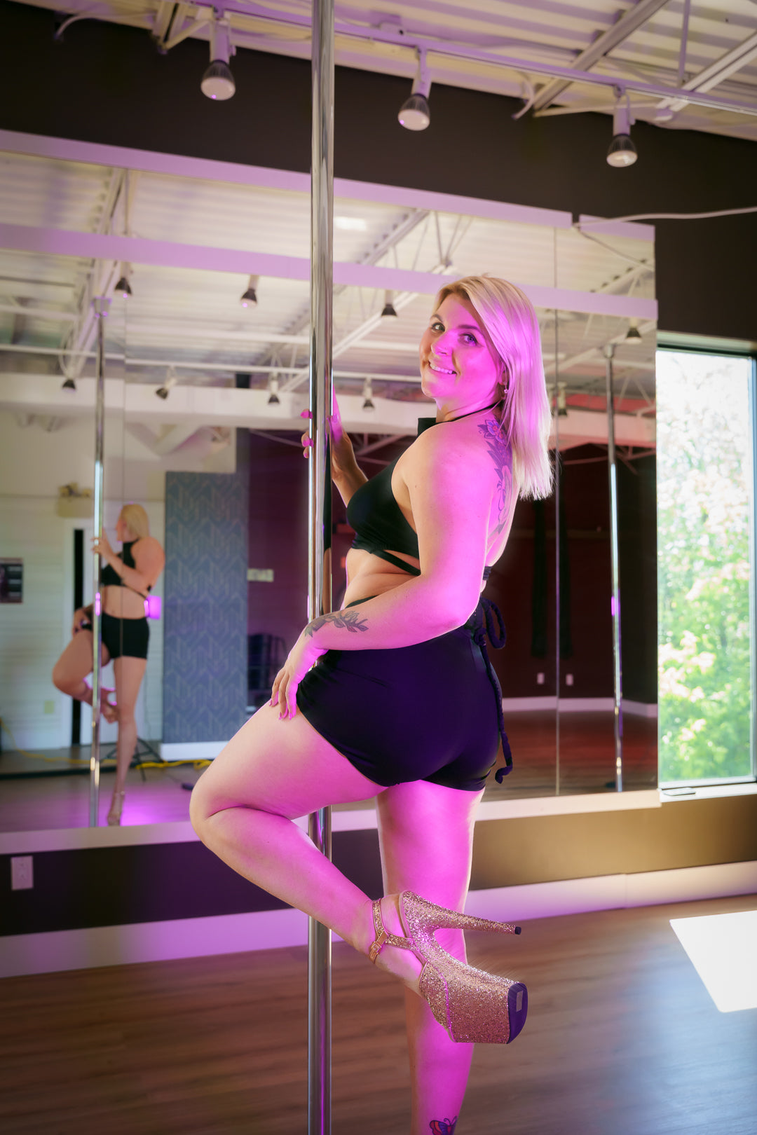 A person doing pole dancing in a pole dance studio in Brossard.